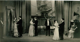 Unnamed play K, nine cast members draped door, wall map and gramophone, [no date].