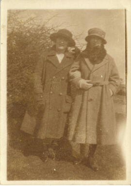 April 1922. Two women in front of hedge.