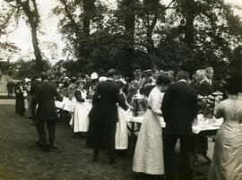 Long table with trees in background.