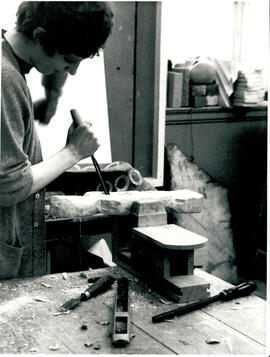 Carving with chisel.