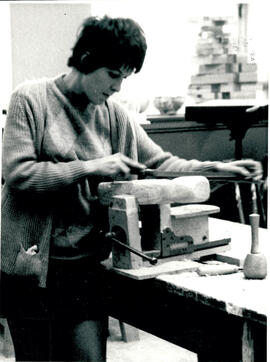 Using file on sculpture with mallet.