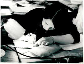 Dissecting fish, under lamp with cable.