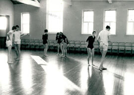 Seven figures in movement.