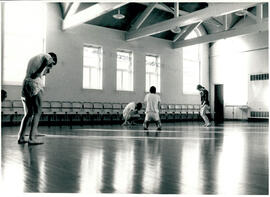 Four figures in movement.