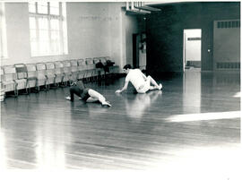 Two figures lying on the floor.